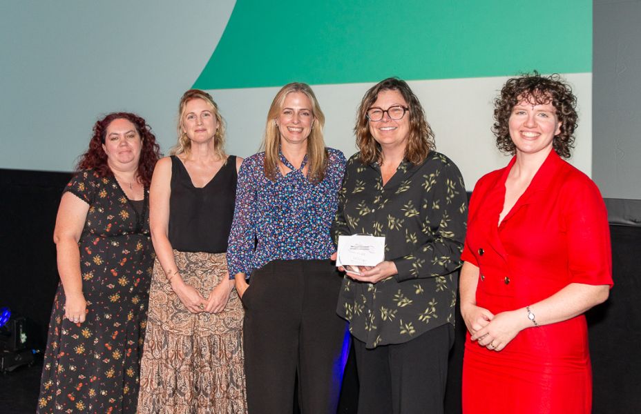 Imago staff members up on stage receiving youth organisation of the year award