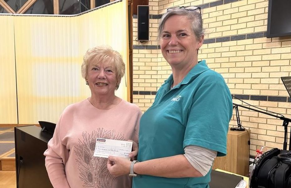 imago staff jo receiving a cheque from thanet serenaders