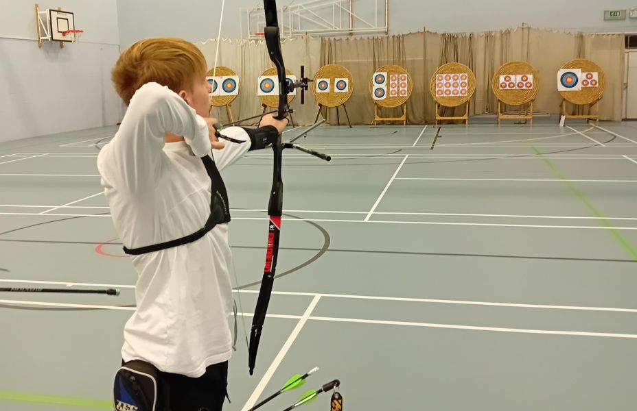 Michael ready to release an arrow towards the targets
