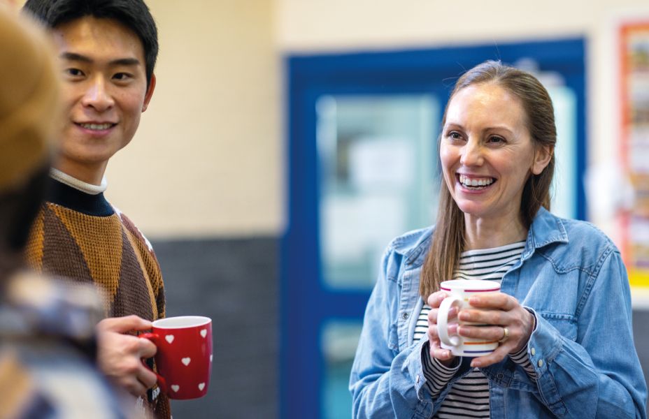 people talking at a networking event holding mugs