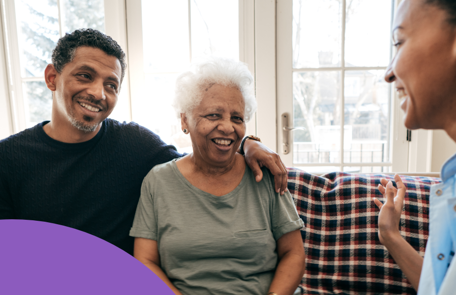 Young adult male sitting with his cared for mother talking with a support coordinator