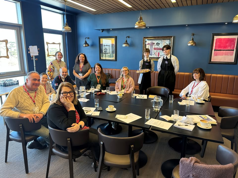 group of people at a meeting sitting round a table