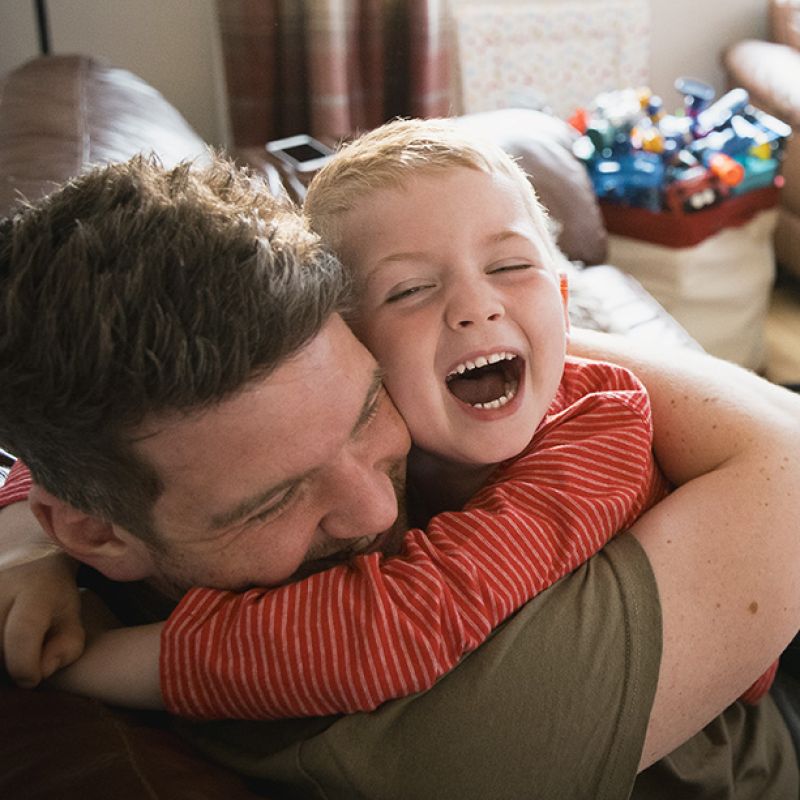 Photo of father and son enjoying a cuddle